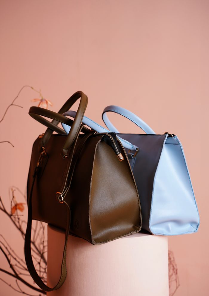 vision Chic designer handbags displayed in an elegant studio setup, highlighting modern fashion accessories.